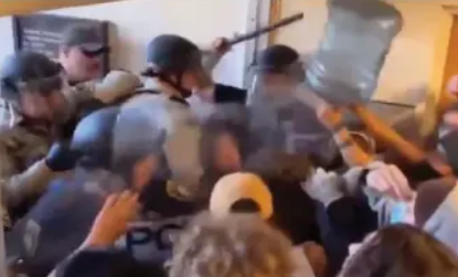 The viral video of the student with the water jug and the riot police.