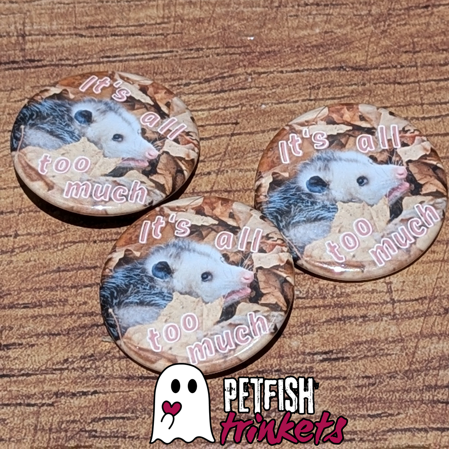 a trio of buttons with an opossum on them
